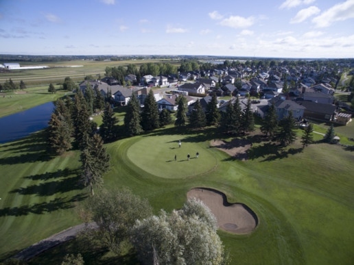 green fairway, putting green and sand bunker at The Links at Spruce Grove