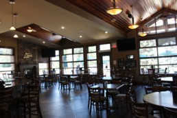 dining room with lots of natural light and a fireplace at The Grill at The Links at Spruce Grove